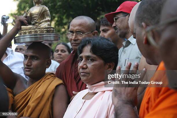 Bahujan Samaj Party supremo Mayawati with Buddhist monks after lighting the funeral pyre of Kanshi Ram, founder of BSP, in New Delhi on Monday....