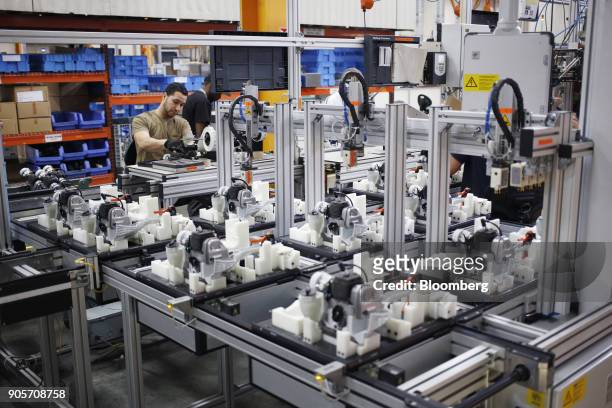Worker assembles string trimmer power tools at the Stihl Inc. Manufacturing facility in Virginia Beach, Virginia, U.S., on Thursday, Jan. 11, 2018....