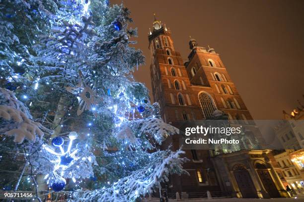 View of Krakow's Rynek Square with Mariacki Basilica just after a snow storm. On Tuesday, January 16 in Krakow, Poland..