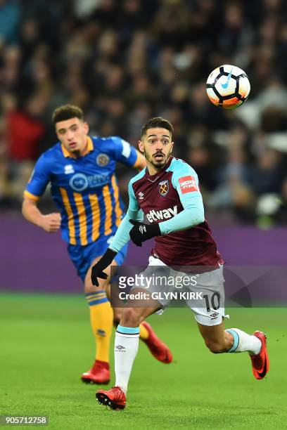 West Ham United's Argentinian midfielder Manuel Lanzini controls the ball during the FA Cup third round replay football match between West Ham United...