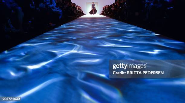 Models present creations by the label "Callisti" during the Fashion Week in Berlin on January 16, 2018. / AFP PHOTO / dpa / Britta Pedersen / Germany...