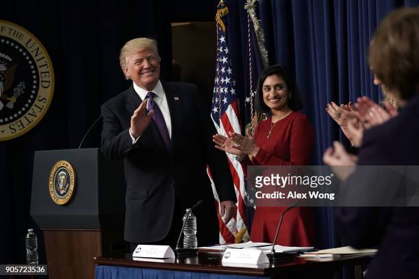 President Donald Trump acknowledges the audience as Administrator of the Centers for Medicare and Medicaid Services Seema Verma looks on as he stops...