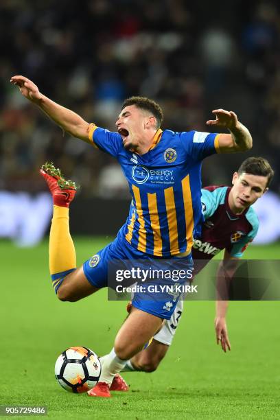 Shrewsbury Town's English midfielder Ben Godfrey is tackled by West Ham United's English-born Irish midfielder Josh Cullen during the FA Cup third...