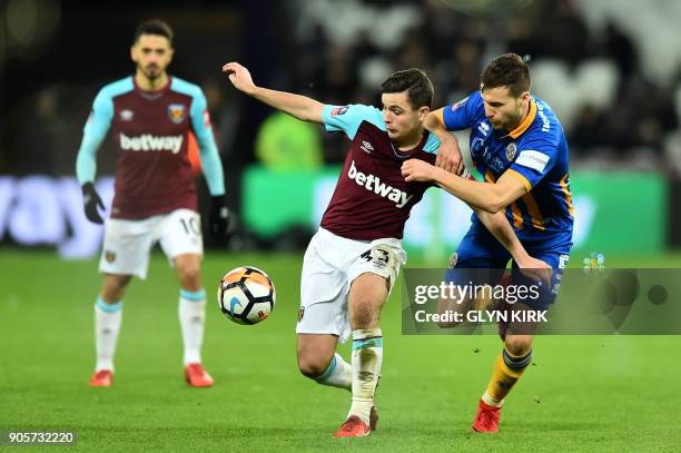 West Ham United's English-born Irish midfielder Josh Cullen is held by Shrewsbury Town's English defender Mat Sadler during the FA Cup third round...