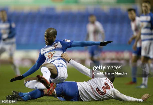 Sone Aluko of Reading is challenegd by Joe Martin of Stevenage during the Emirates FA Cup Third Round Replay match between Reading and Stevenage at...