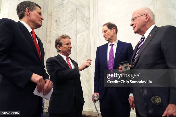 Sen. Steve Daines , Sen. Rand Paul , Sen. Ron Wyden and Sen. Patrick Leahy talk strategy before a news conference about their proposed reforms to the...
