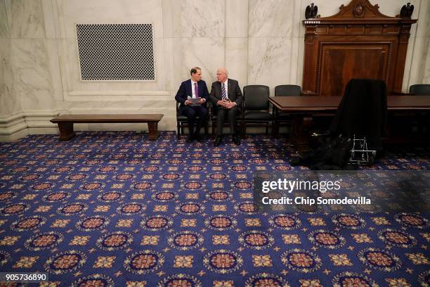 Sen. Ron Wyden talks with Sen. Patrick Leahy before a news conference about their proposed reforms to the Foreign Intelligence Surveillance Act in...