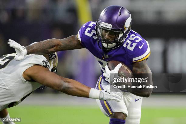 Latavius Murray of the Minnesota Vikings carries the ball against Craig Robertson of the New Orleans Saints during the first half of the NFC...