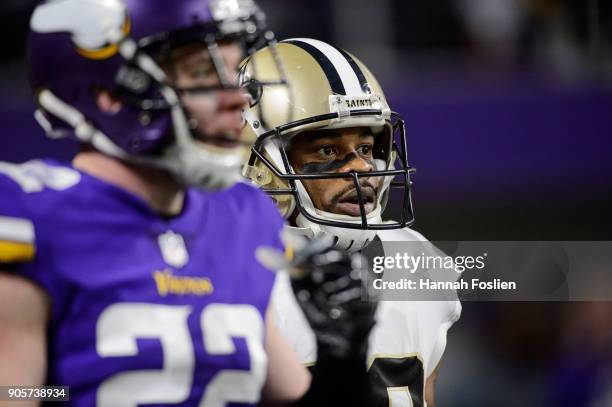 Ted Ginn of the New Orleans Saints and Harrison Smith of the Minnesota Vikings look on during the first half of the NFC Divisional Playoff game on...
