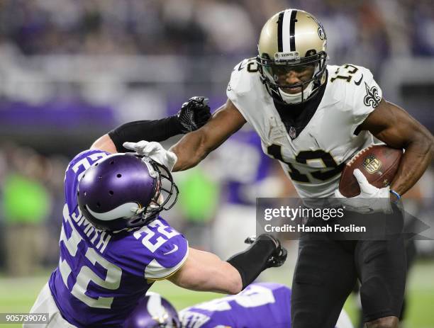Michael Thomas of the New Orleans Saints carries the ball against Harrison Smith of the Minnesota Vikings during the first half of the NFC Divisional...