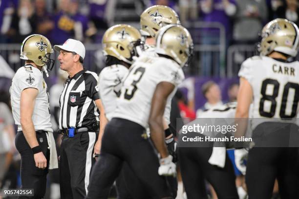 Drew Brees of the New Orleans Saints speaks with referee Gene Steratore during the first half of the NFC Divisional Playoff game against the...