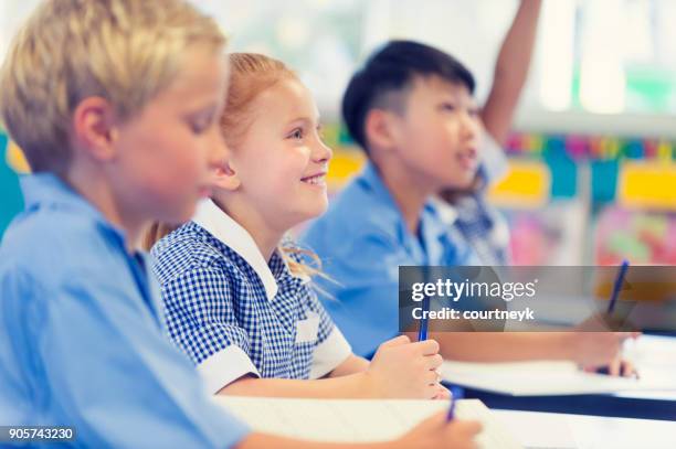 group of children listening to the teacher. - girl thinking stock pictures, royalty-free photos & images