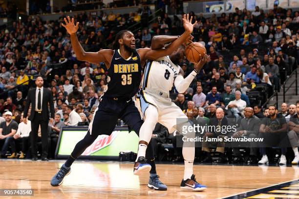 James Ennis III of the Memphis Grizzlies battles Kenneth Faried of the Denver Nuggets for a rebound at Pepsi Center on January 12, 2018 in Denver,...