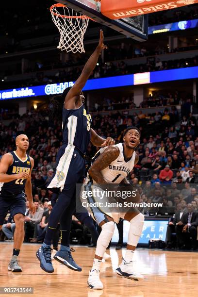 Jarell Martin of the Memphis Grizzlies drives against Kenneth Faried of the Denver Nuggets at Pepsi Center on January 12, 2018 in Denver, Colorado....