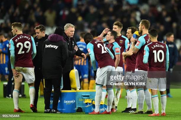 West Ham United's Scottish manager David Moyes talks to his players before extra time during the FA Cup third round replay football match between...