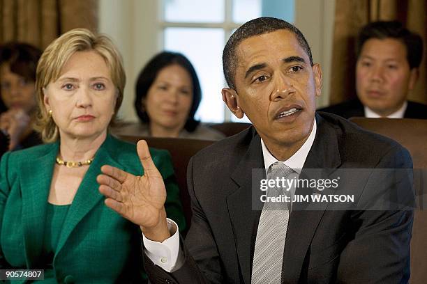 President Barack Obama speaks with US Secretary of State Hillary Rodham Clinton and others during a cabinet meeting at the White House in Washington,...