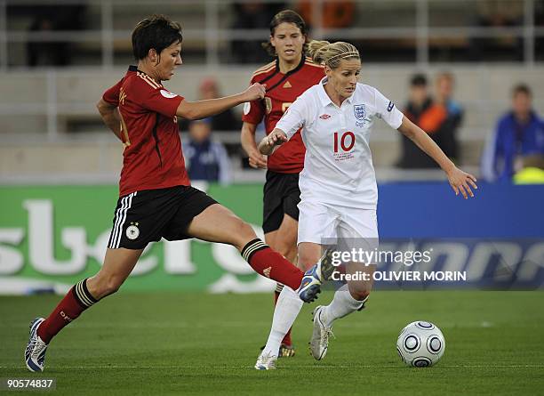 Germany's Linda Bresonik -L- struggles for the ball with England's Kelly Smith during the final of the Women's EURO 2009 Germany vs England, on...