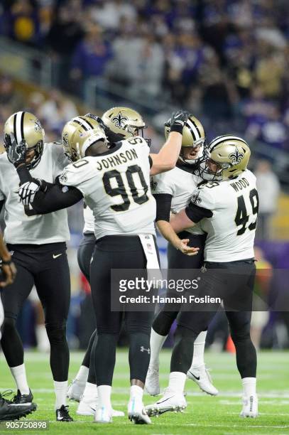 The New Orleans Saints congratulates kicker Wil Lutz after a field goal against the Minnesota Vikings during the second half of the NFC Divisional...
