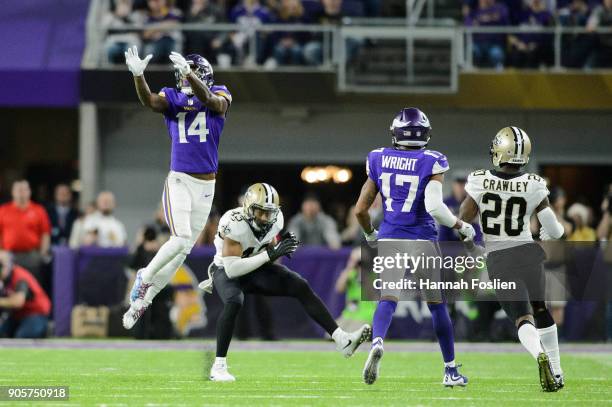 Stefon Diggs of the Minnesota Vikings jumps to make a catch over Marcus Williams of the New Orleans Saints as Jarius Wright of the Minnesota Vikings...