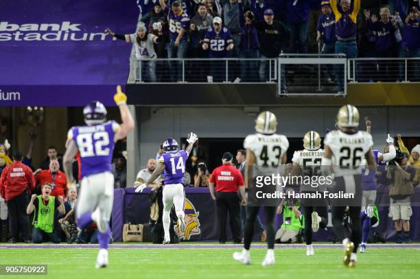 Kyle Rudolph and Stefon Diggs of the Minnesota Vikings celebrate a touchdown by Diggs as Marcus Williams, Craig Robertson and P.J. Williams of the...