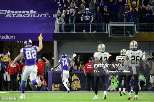 Kyle Rudolph and Stefon Diggs of the Minnesota Vikings celebrate a touchdown by Diggs as Marcus Williams, Craig Robertson and P.J. Williams of the...