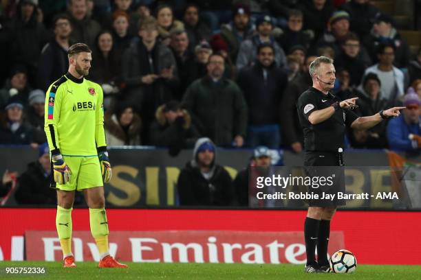Referee Jonathan Moss uses the VAR during The Emirates FA Cup Third Round Replay match between Leicester City and Fleetwood Town at The King Power...