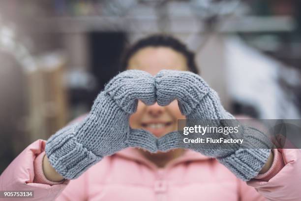 showing some love - gray glove stock pictures, royalty-free photos & images