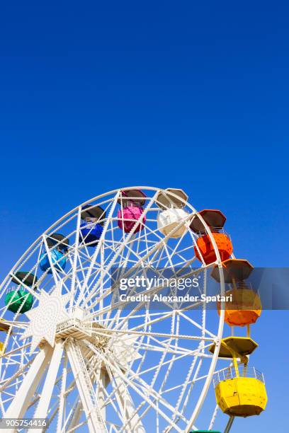 vibrant colorful ferris wheel against clear blue sky in barcelona, spain - tibidabo fotografías e imágenes de stock