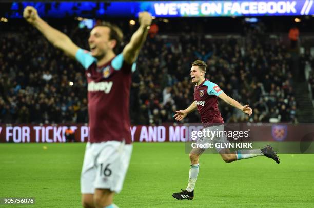 West Ham United's English defender Reece Burke celebrates scoring the team's first goal during the FA Cup third round replay football match between...