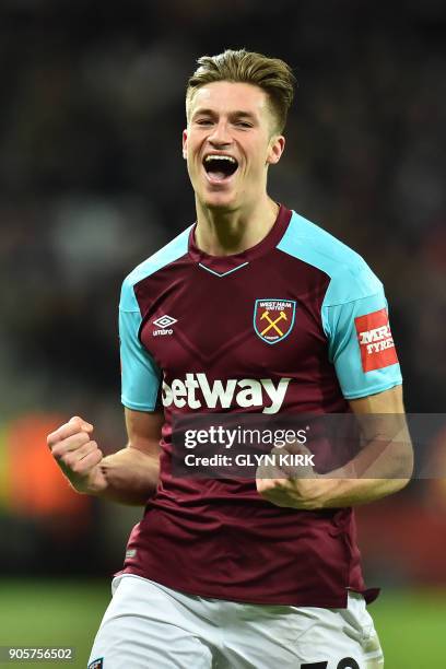 West Ham United's English defender Reece Burke celebrates scoring the team's first goal during the FA Cup third round replay football match between...