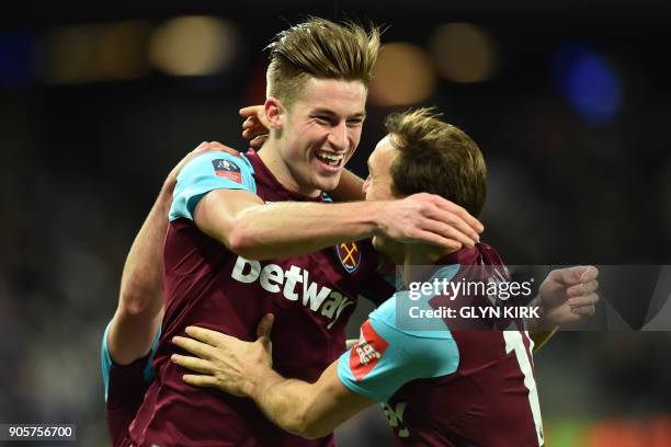 West Ham United's English defender Reece Burke celebrates scoring the team's first goal during the FA Cup third round replay football match between...