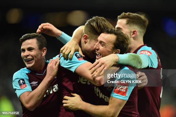 West Ham United's English defender Reece Burke celebrates scoring the team's first goal with teammates during the FA Cup third round replay football...