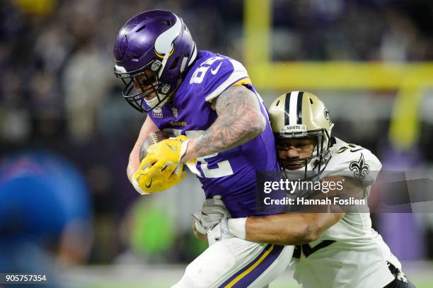 Craig Robertson of the New Orleans Saints pushes Kyle Rudolph of the Minnesota Vikings out of bounds during the second half of the NFC Divisional...