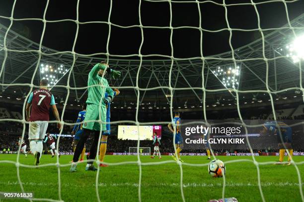 Shrewsbury Town's English goalkeeper Dean Henderson reacts after West Ham United's English defender Reece Burke scores the winning goal during the FA...