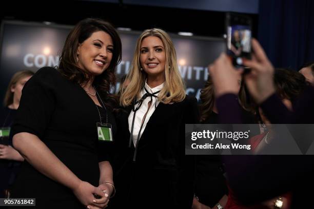 Ivanka Trump , Adviser and daughter of President Donald Trump, poses for photos with a guest during a Conversations with the Women of America panel...