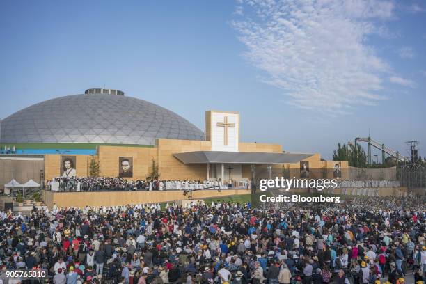 Attendees stand as Pope Francis, not pictured, arrives to give mass at O'Higgins Park in Santiago, Chile, on Tuesday, Jan. 16, 2018. 400,000 Chileans...