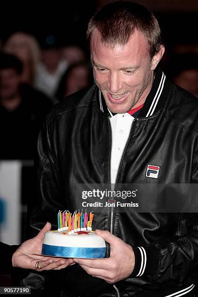 Director Guy Ritchie accepts a cake for his 41st birthday today at the UK Premiere of 'The Firm' at Vue West End on September 10, 2009 in London,...