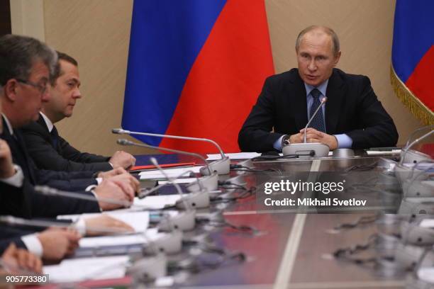 Russian President Vladimir Putin speeches as Prime Miniter Dmitry Medvedev looks on during their weekly meeting with minister of Russian Government...