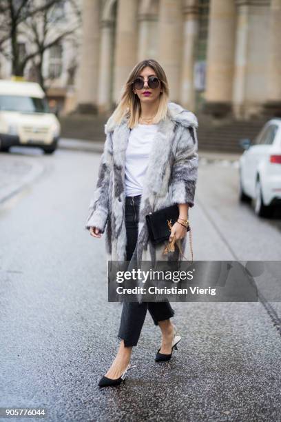 Aylin Koenig wearing Riani shirt, Riani coat, Dior shoes, Zara cropped denim jeans, Dolce & Gabbana sunglasses, Yves Saint Laurent bag is seen during...