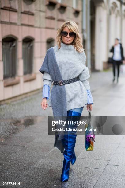 Gitta Banko wearing a light-blue blouse with trompe sleeves by Smith & Soul, grey, oversize turtleneck knit sweater by Smith & Soul, jeans by Current...