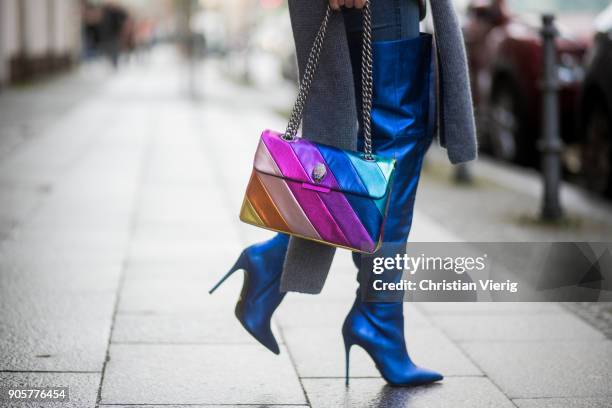 Gitta Banko wearing a light-blue blouse with trompe sleeves by Smith & Soul, grey, oversize turtleneck knit sweater by Smith & Soul, jeans by Current...