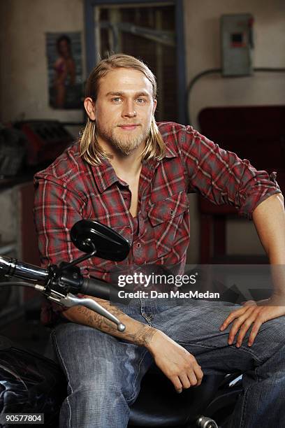 Actor Charlie Hunnam poses with his character's Harley Davidson Dyna on the set of TV show Sons of Anarchy.