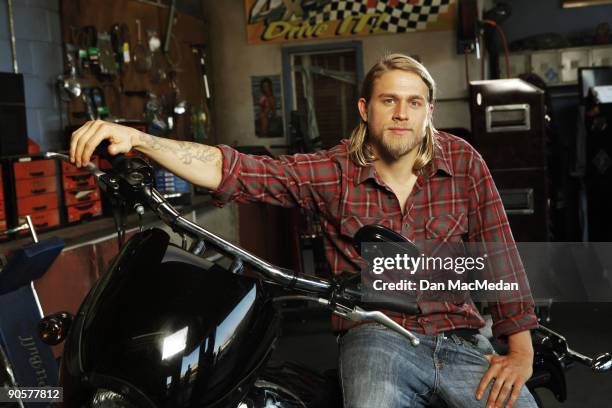 Actor Charlie Hunnam poses with his character's Harley Davidson Dyna on the set of TV show Sons of Anarchy.