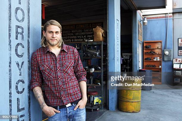 Actor Charlie Hunnam poses with his character's Harley Davidson Dyna on the set of TV show Sons of Anarchy.