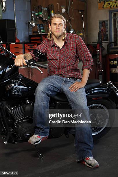 Actor Charlie Hunnam poses with his character's Harley Davidson Dyna on the set of TV show Sons of Anarchy.