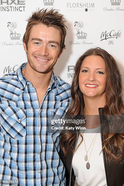 Robert Buckley poses for a picture next to Heather Mitchell as they attends the AXE Instinct Sponsored Duckie Brown Spring 2010 Fashion Show at...