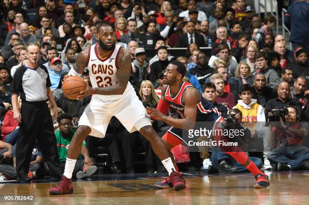 LeBron James of the Cleveland Cavaliers handles the ball against John Wall of the Washington Wizards at Capital One Arena on December 17, 2017 in...