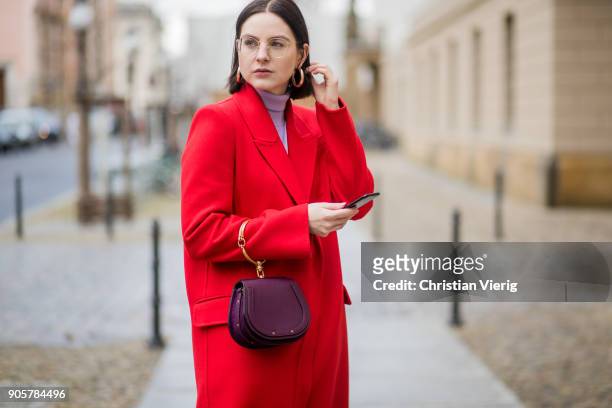 Maria Barteczko wearing long red cashmere coat Alexander McQueen, light pink turtleneck sweater Asos, big hoop earrings H&M, black high heels...