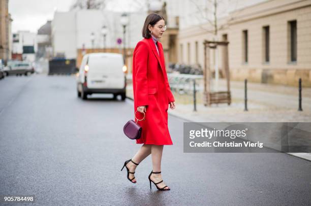 Maria Barteczko wearing long red cashmere coat Alexander McQueen, light pink turtleneck sweater Asos, big hoop earrings H&M, black high heels...