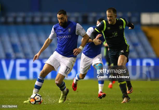 Atdhe Nuhiu of Sheffield Wednesday beats Danny Grainger of Carlisle United during the Emirates FA Cup Third Round Replay match between Sheffield...